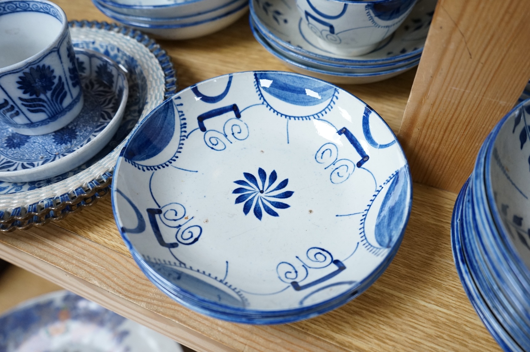 A group of 19th century pearlware set of tea bowls and saucers and to similar basket with border plates